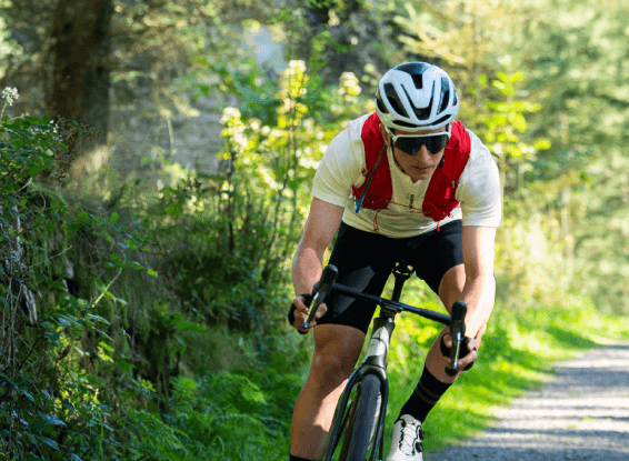 Cyclist eating an OGT bar mid-ride