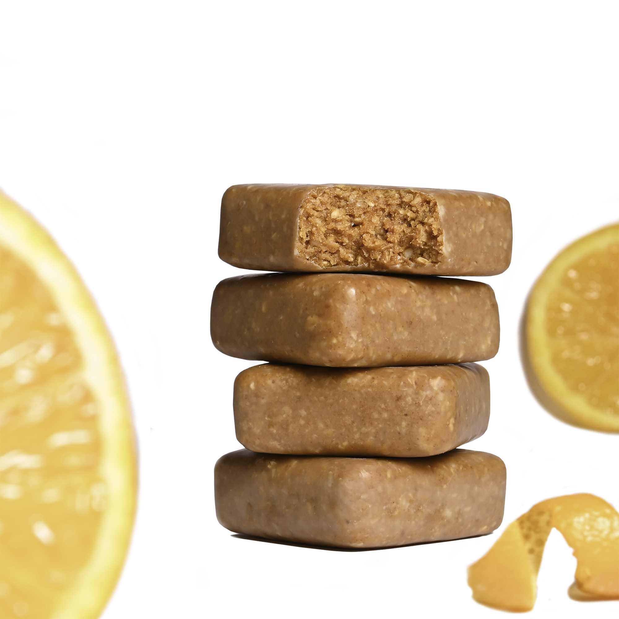 Stack of Performance² Dual-Carb & Electrolyte Energy Bars with orange slices and an orange zest on a white background.