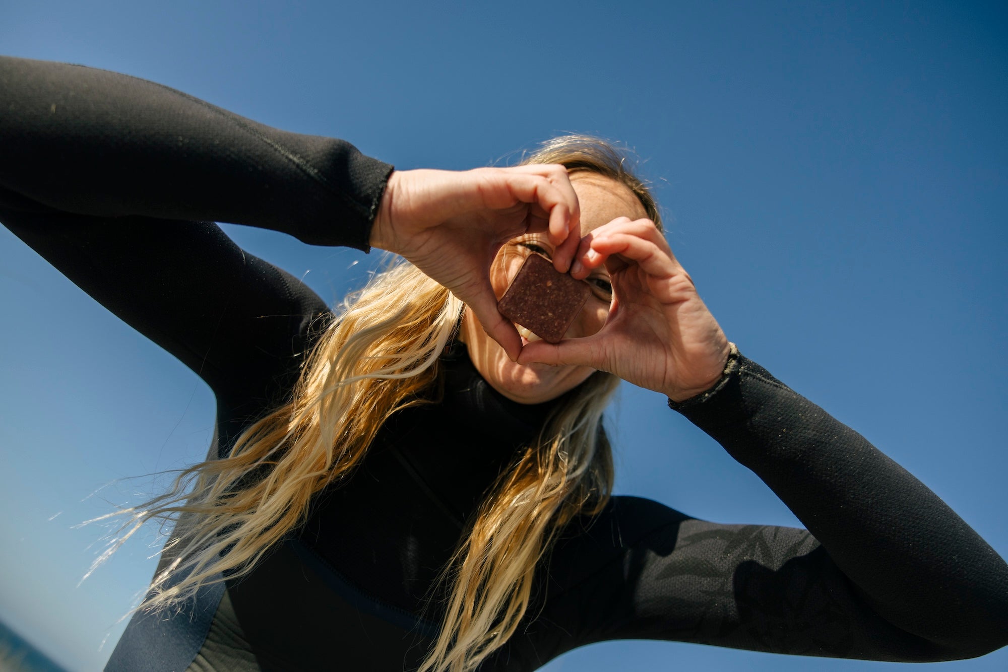 Beth making a heart shape with her hands and an OGT bar